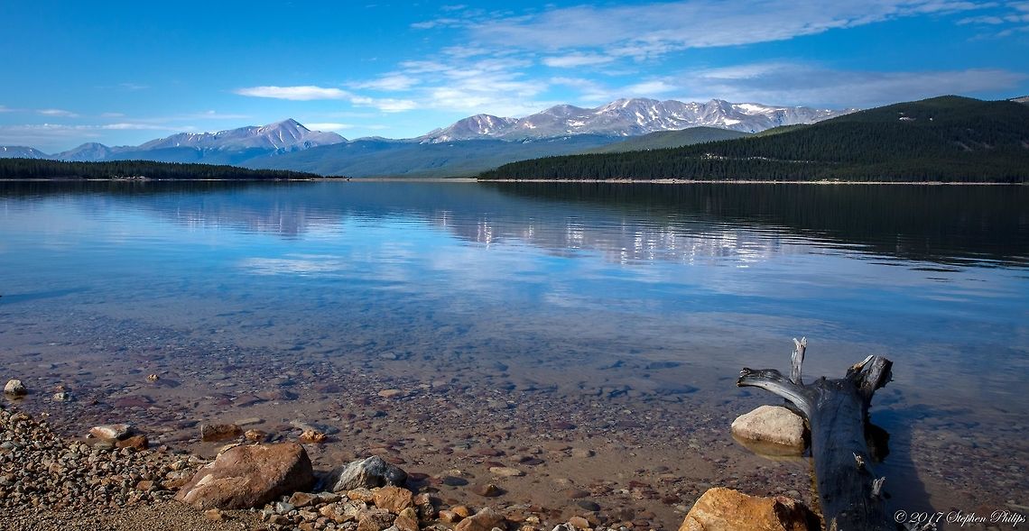 Turquoise Lake Turquoise Lake is a 1,788-acre, boot-shaped reservoir on the Lake Fork of the Arkansas River west of Leadville. The high-altitude lake is part of the Fryingpan-Arkansas water development project, delivering water to Front Range cities from the western slope. Turquoise Lake lies in the shadow of high mountains, including Mount Elbert and , Colorado’s two highest peaks. A 4,928-acre Forest Service recreation area surrounds the lake and includes eight campgrounds with 269 campsites, picnic areas, and two boat launches. Campers and fishermen, who angle for brown, rainbow, cutthroat and lake trout, as well as hikers, primarily use the area. Geotagged,Summer,United States