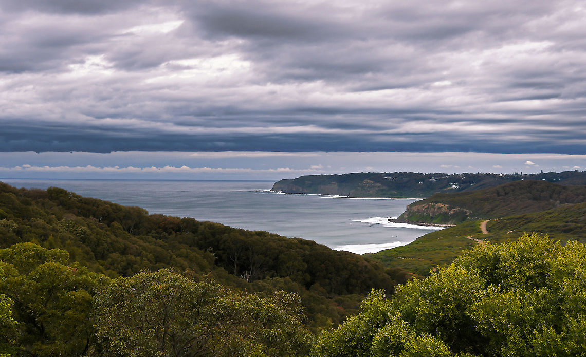 Pacific coast blues Some low and intriguing clouds on this day over Glenrock.<br />
<br />
Glenrock State conservation area is littoral rainforest -  the structure and composition of which is strongly influenced by its proximity to the ocean.<br />
<br />
The forest  encompasses 534 hectares/1319 acres.<br />
<br />
There are many threats to these endangered ecological communities.  Australia,Geotagged,Glenrock Conservation area,Pacific coast,South Pacific ocean,Winter,forest,landscape,littoral rainforest,nature reserve,new south wales,scenery,trees