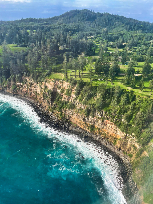 Flying over the Pacific to Norfolk Island Norfolk Island is a tiny, external territory of Australia located way out in the Pacific Ocean. It lies 1412 km (877 m) directly east of Evan&#039;s Head which is on our New South Wales east coast. <br />
<br />
The first known settlers on Norfolk Island were East Polynesian people, but they had already departed when Great Britain settled it as part of their 1788 arrival to these lands.<br />
<br />
Today, there are around 1800 people who call the island home. <br />
<br />
Native to the island, the evergreen Norfolk Island pine is a symbol of the island and features on the flag. The pine is a popular ornamental tree here in Australia and now worldwide I believe. <br />
<br />
 <br />
<br />
 Araucaria heterophylla,Araucariaceae,Australian landscape,Fall,Geotagged,Norfolk Island,Norfolk Island pine,Pacific Ocean,Pinales,autumn