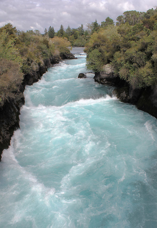 Waikato River New Zealand The Huka Falls are a set of waterfalls on the Waikato River that drains Lake Taupo in New Zealand.<br />
A few hundred metres upstream from the Huka Falls, the Waikato River narrows from approximately 100 metres across into a canyon only 15 metres across. The canyon is carved into lake floor sediments laid down before Taupo's Oruanui eruption 26,500 years ago. <br />
The volume of water flowing through can reach 220,000 litres per second - the roar was tremendous, the colour of the water spectacular! <br />
 Geotagged,Huka Falls,New Zealand,River,Taupo District,Waikato River,autumn,landscape,scenery,water,wild landscape