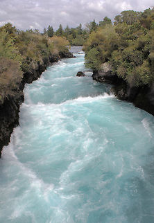 Waikato River New Zealand The Huka Falls are a set of waterfalls on the Waikato River that drains Lake Taupo in New Zealand.
A few hundred metres upstream from the Huka Falls, the Waikato River narrows from approximately 100 metres across into a canyon only 15 metres across. The canyon is carved into lake floor sediments laid down before Taupo's Oruanui eruption 26,500 years ago. 
The volume of water flowing through can reach 220,000 litres per second - the roar was tremendous, the colour of the water spectacular! 
 Geotagged,Huka Falls,New Zealand,River,Taupo District,Waikato River,autumn,landscape,scenery,water,wild landscape