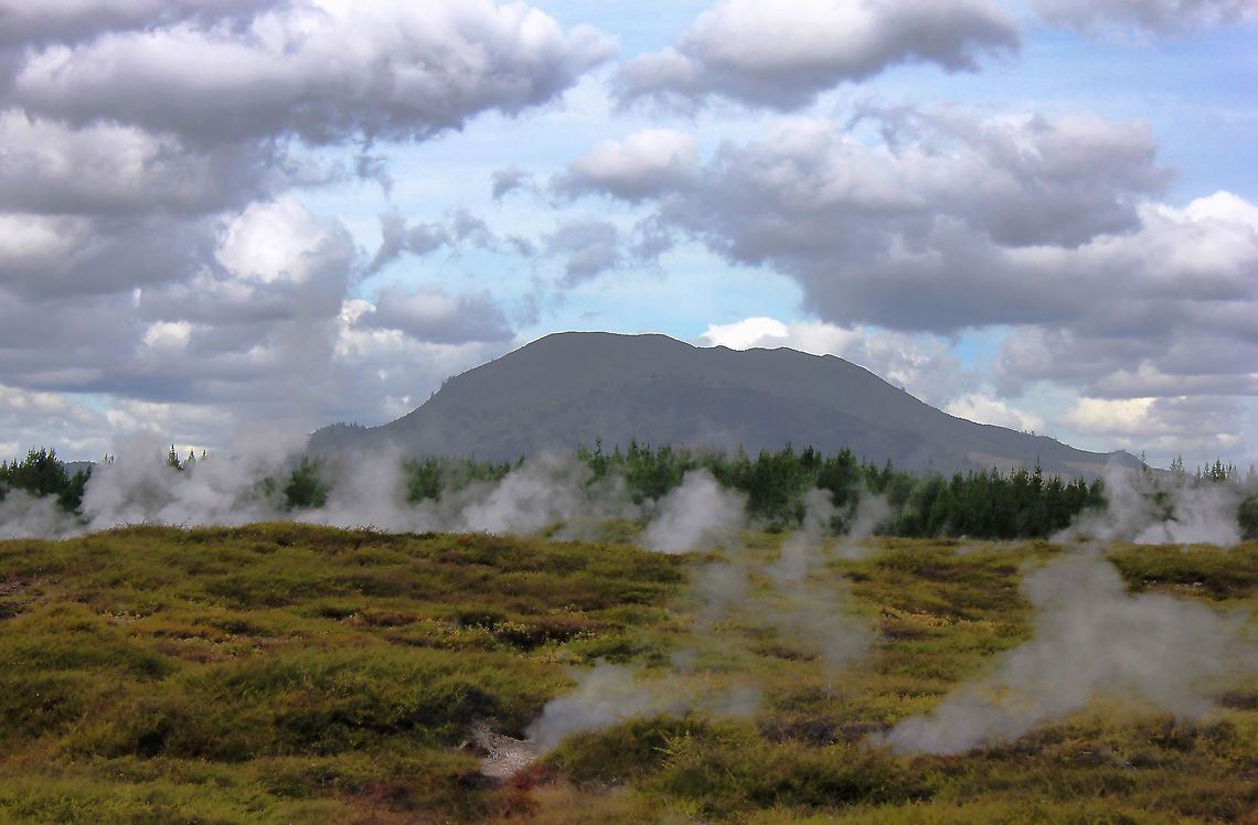 Above and below On this day, I was surrounded by clouds both above and below! <br />
<br />
Wairakei&rsquo;s Craters of the Moon geothermal area is part of the largest geothermal field in New Zealand. It lies within the Taupō Volcanic Zone.<br />
<br />
Despite being on raised wooden boardwalks, one can feel the heat of the Earth while exploring this geothermal valley hissing with clouds of steam and cauldrons full of bubbling mud. If memory serves, this is Mt Tongariro in the background -  an active, compound volcano. <br />
<br />
The thermal activity is monitored regularly by scientists from the Institute of Geological and Nuclear Science.  Autumn,Fall,Geotagged,Geothermal,Mt Tongariro,New Zealand,Taupō Volcanic Zone,Waikato,Wairakei,active volcano,compound volcano,landscape,volcano