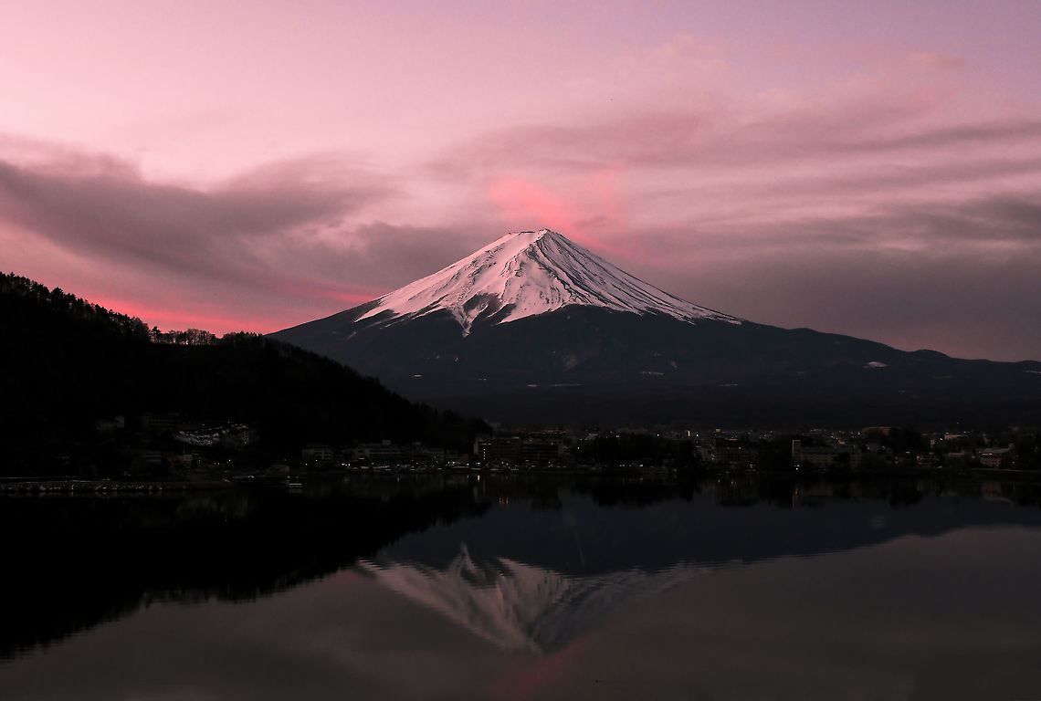 First light over Fuji-san The mighty, the sacred, the eternally mysterious - central to the identity of Japan and her people. <br />
<br />
For me, a pilgrimage of sorts; to finally stand before this most beautiful of natural wonders, a deeply moving 24 hours in my life. Fuji-san leaves one breathless and bewildered. Parting earth and sky with remarkable symmetry, its beauty beyond description in text or letter, no poem powerful enough to create the emotion in one&#039;s heart and mind upon seeing for the first time, in person and close at hand.<br />
<br />
I arose the second morning at 5am to witness first light falling on the sleeping giant, and the sunrise upon Lake Kawaguchiko before me.<br />
<br />
Mount Fuji is an active stratovolcano and the tallest mountain in Japan, standing at 3,776 meters (12,380 feet). Fuji-san,Geotagged,Honshu,Japan,Lake Kawaguchiko,Mount Fuji,Volcano,Winter,landscape,mountain,scenery,stratovolcano