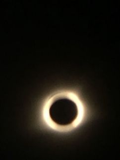 2017 Great American Eclipse: Totality Finally was able to download my eclipse photos from my computer to my phone! This was taken in 2017 on August 21st during the Great American Eclipse. We drove from central Wisconsin all the way down to the tip of the Illinois to the line of totality just so we could see this, and it was absolutely worth it. I took this by clipping my eclipse glasses over the the camera lens of my phone, then clipping a macro lens over that. That blue around it you see isn’t actually camera error, that’s the sun’s corona! We got to see bailey’s beads, the diamond ring, and the rare unexplained shadow snakes! Definitely an amazing trip, here’s to hoping South Dakota holds a candle to it. Eclipse,Geotagged,Natural events,United States,solar eclipse,sun,totality