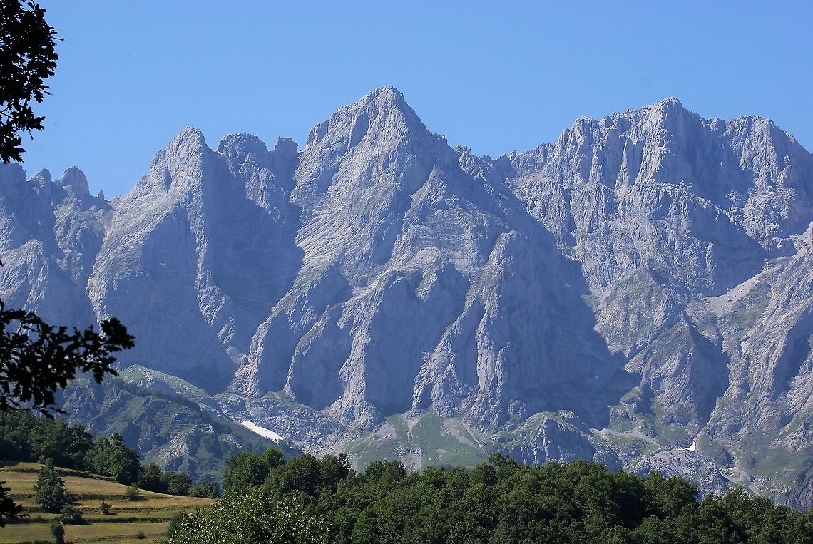 Limestone peaks in the Picos de Europa The glorious limestone peaks in one of the less visited national parks in Spain, with hay meadow to left Cantabria,Picos de Europa,Spain