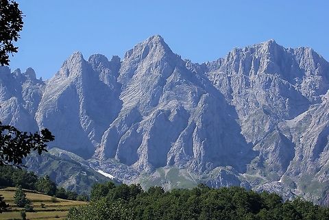 Limestone peaks in the Picos de Europa The glorious limestone peaks in one of the less visited national parks in Spain, with hay meadow to left Cantabria,Picos de Europa,Spain