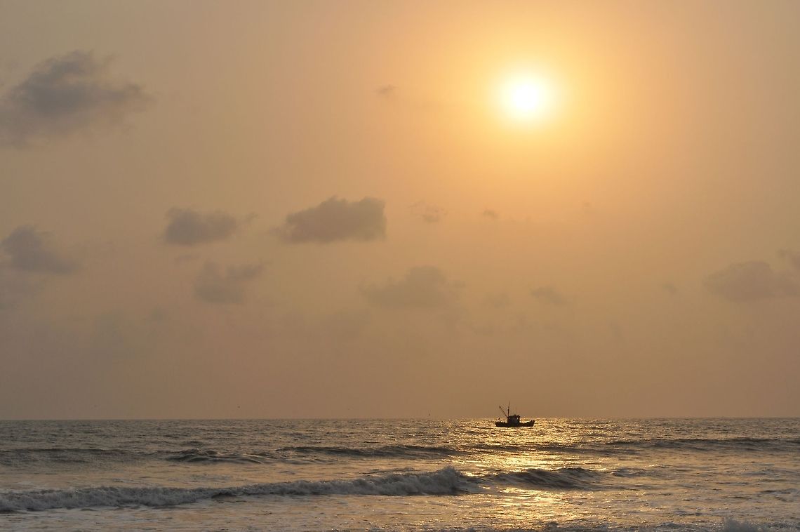 Colva Goa sunset I was at the beach in Colva, Goa. The sun was about to set. I waited till the boat reached in line with the sun and snapped this shot. Geotagged,India,sunset
