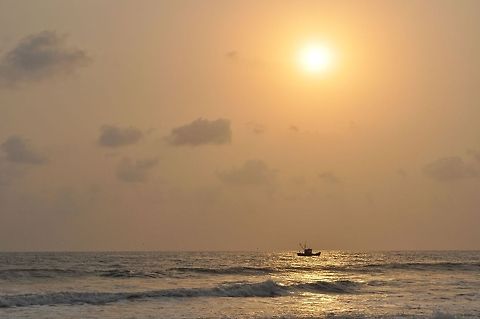 Colva Goa sunset I was at the beach in Colva, Goa. The sun was about to set. I waited till the boat reached in line with the sun and snapped this shot. Geotagged,India,sunset