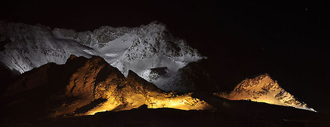 snowy mountains A panoramic view of the mountains at Val Thorens in France. At one evening they lit the mountains surrounding the village. France,Geotagged,Mountains