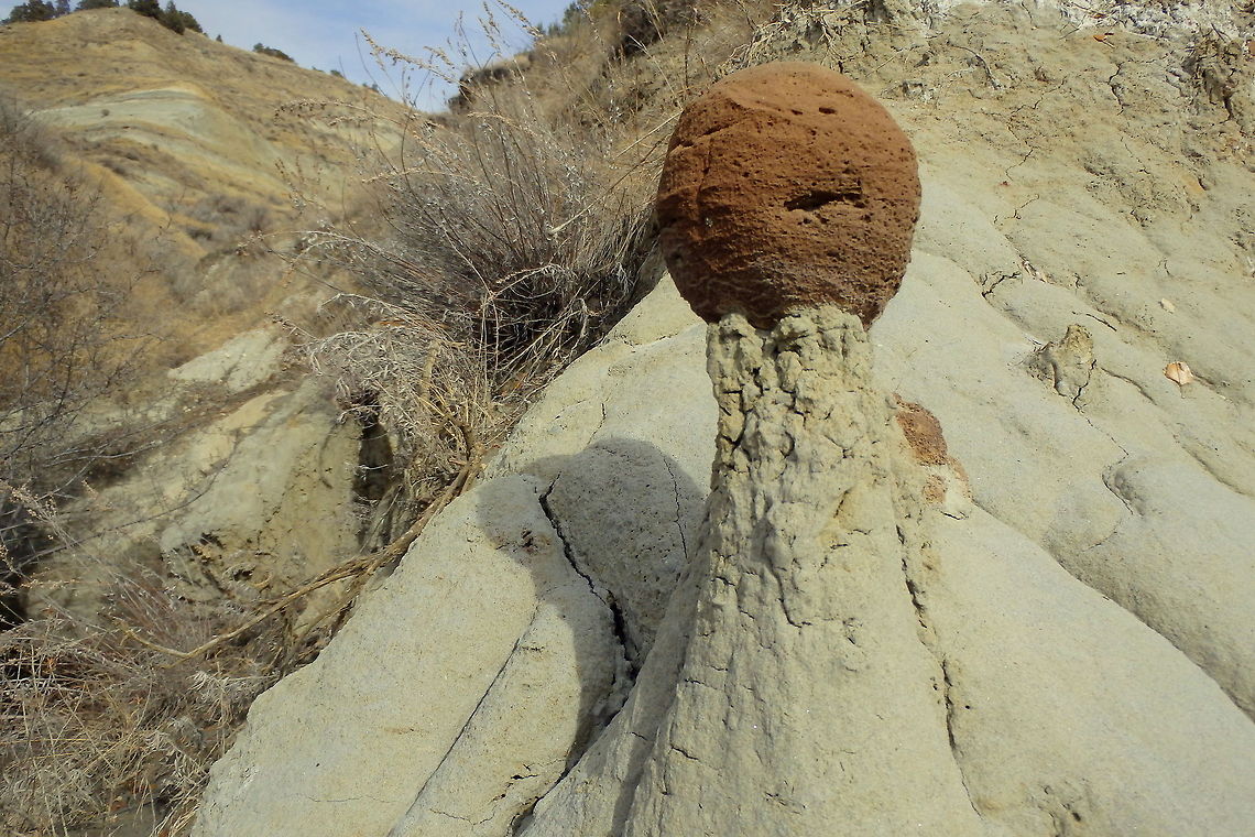 Cannonball Concretion A sandstone and clay pillar that has been eroded by rain and wind holds up a round, fist-sized rock made of scoria. Captured in the North Unit of Teddy Roosevelt National Park, North Dakota. Geotagged,North Dakota,Theodore Roosevelt National Park,United States