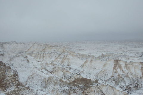 Blizzard in the Badlands A spring blizzard blows through Badlands National Park in South Dakota, bringing with it snow, sleet and 60 mph (96 kph) winds. Would you believe I was the only person there that day? These are, in my opinion, the best days to experience such places, in total and complete solitude. Badlands National Park,Geotagged,South Dakota,United States,landscapes,spring