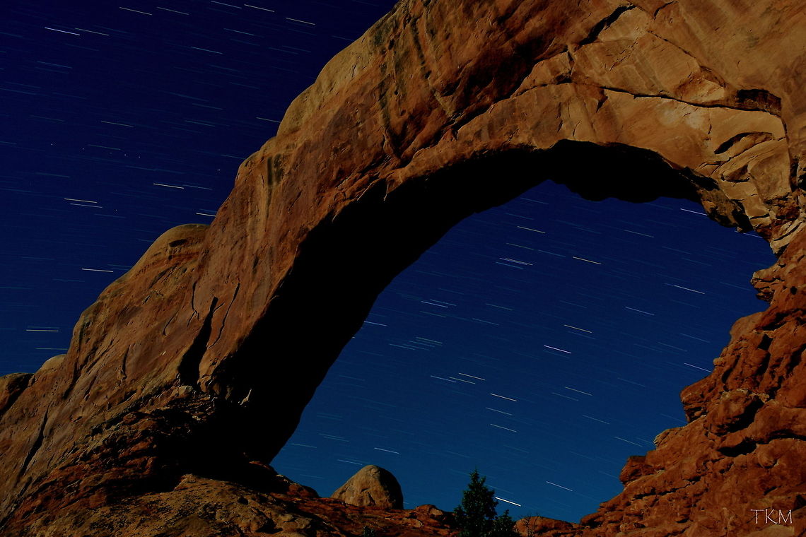 North Window Arch - Night Photography This is a photo of North Window Arch in Arches National Park taken in the very early morning ours. The shutter time on this photo is approximately 10 minutes. If you notice the dotted line to the upper left of the arch, that is actually a satellite orbiting earth. The light was provided by the moon, which actually turned out quite nice in my opinion! Arches National Park,Geotagged,Landscapes,Night,United States,Utah,fall
