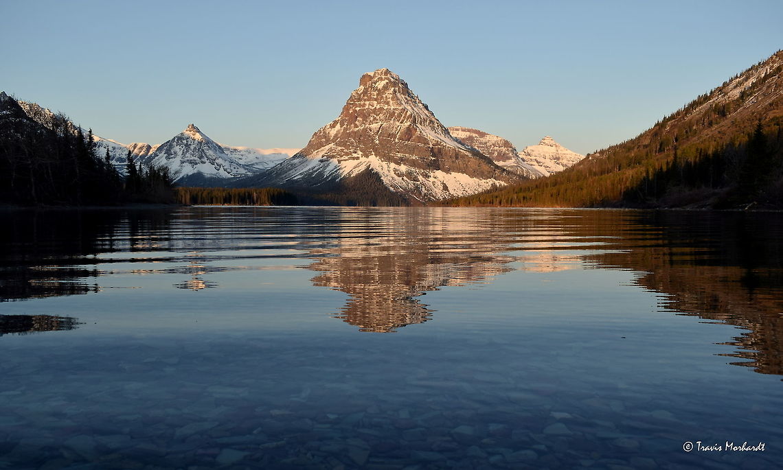 Sinopah Mountain Sinopah Mountain is an icon of the East Glacier Area. Found in Montana&#039;s Glacier National Park, it rises above Two Medicine Lake and is a popular attraction to see. I was fortunate enough to see it in the off-season without anybody else around to interrupt the peace and quiet of a below-freezing morning in the mountains. Geotagged,Glacier National Park,Montana,Mountains,Spring,Sunrise,United States
