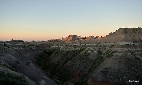 Badlands National Park Sunrise The rising sun illuminates the sand cliffs in South Dakota's Badlands National Park. This place is one of my favorites to watch the sun set and rise both for the beauty and for the lack of people. Badlands National Park,Geotagged,South Dakota,Summer,Sunrise,United States