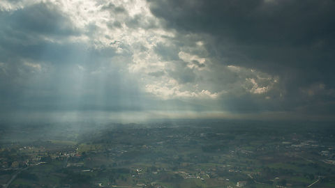 RAY OF THE SUN Shafts of sunlight break through the clouds illuminating the landscape below. Landscapes,Light beam
