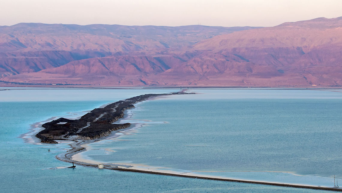 Dead Sea landscape view A very wide view of the Dead See, with bright blue water and colorful mountains in the background. Dead Sea,Geotagged,Landscapes,Spring