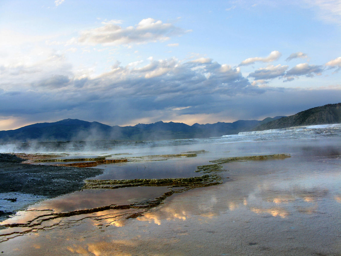 Mammoth Hot Springs Mammot Hot Springs landscape view giving a clear overview of the terrace, mountain ranges and dramatic sky. Landscapes,Wyoming,Yellowstone National Park