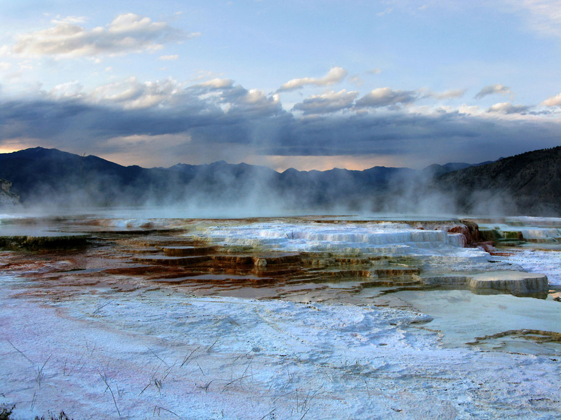 Mammoth Hot Springs 7 Landscape view of the Mammoth Hot Springs, with threatening clouds and geyser steam arising. Landscapes,Wyoming,Yellowstone National Park