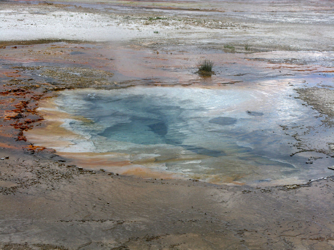 Yellowstone Small Geyser Blue, orange, red colored water steams at Yellowstone National Park. Geyser,Landscapes,Wyoming,Yellowstone National Park