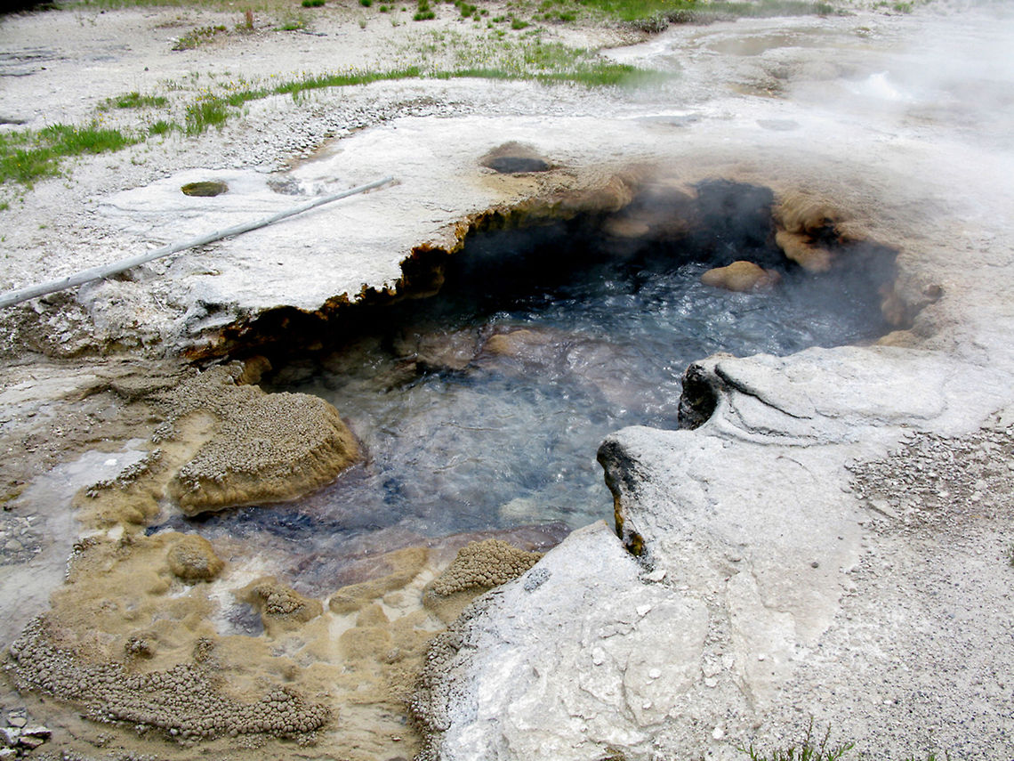Yellowstone Small Geyser 2 A white rocky crust surrounds the steaming hot water at YellowStone. Geyser,Landscapes,Wyoming,Yellowstone National Park