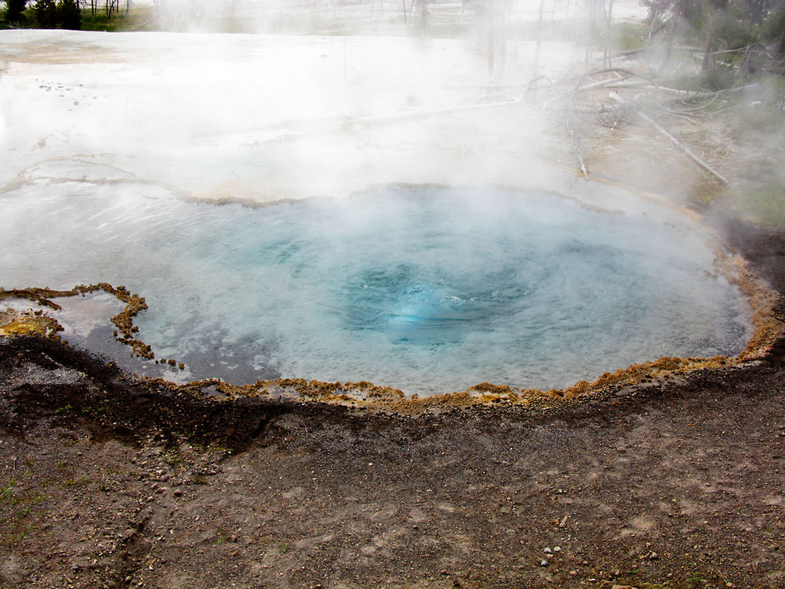 Yellowstone Small Geyser 3 A small bue geyser steams at Yellowstone. Geyser,Landscapes,Wyoming,Yellowstone National Park