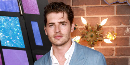 Gregg Sulkin posing at Wizards Beyond Waverly Place premiere