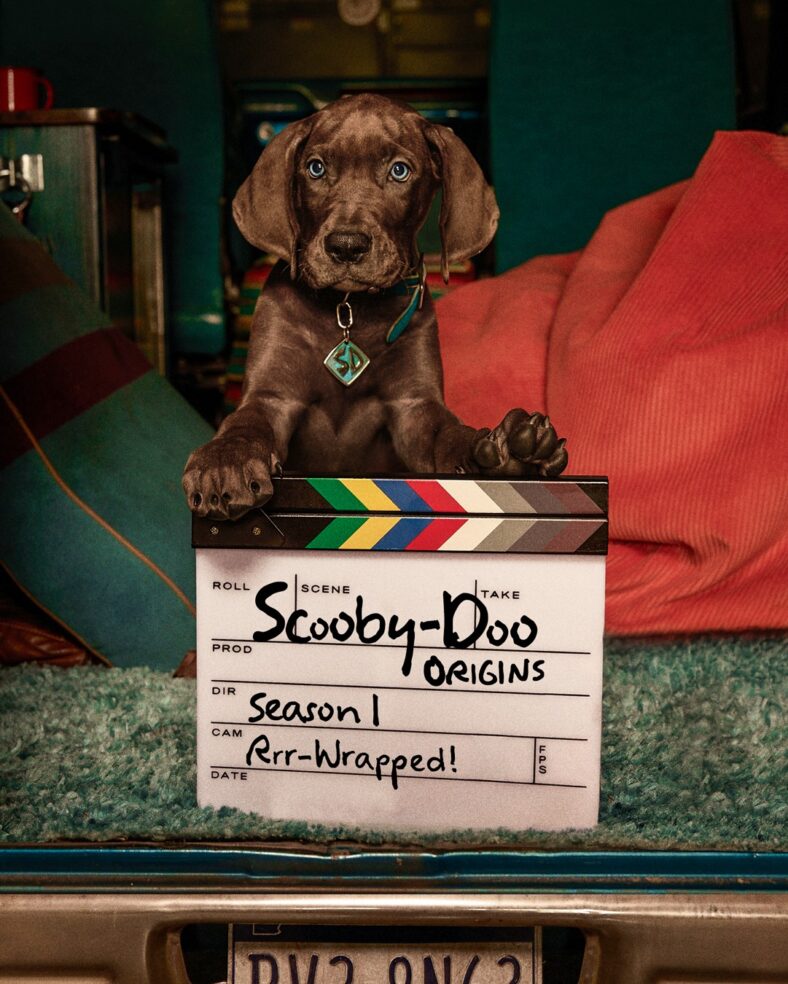 Production wrap photo from Scooby-Doo: Origins featuring the dog posing with a wrapped slate
