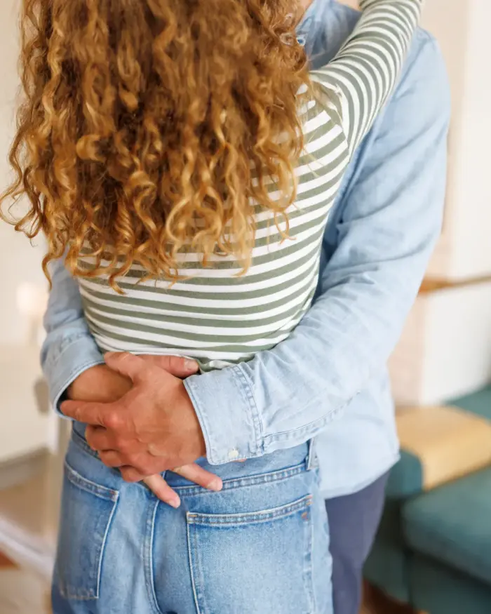 Man and woman holding each other at the waist