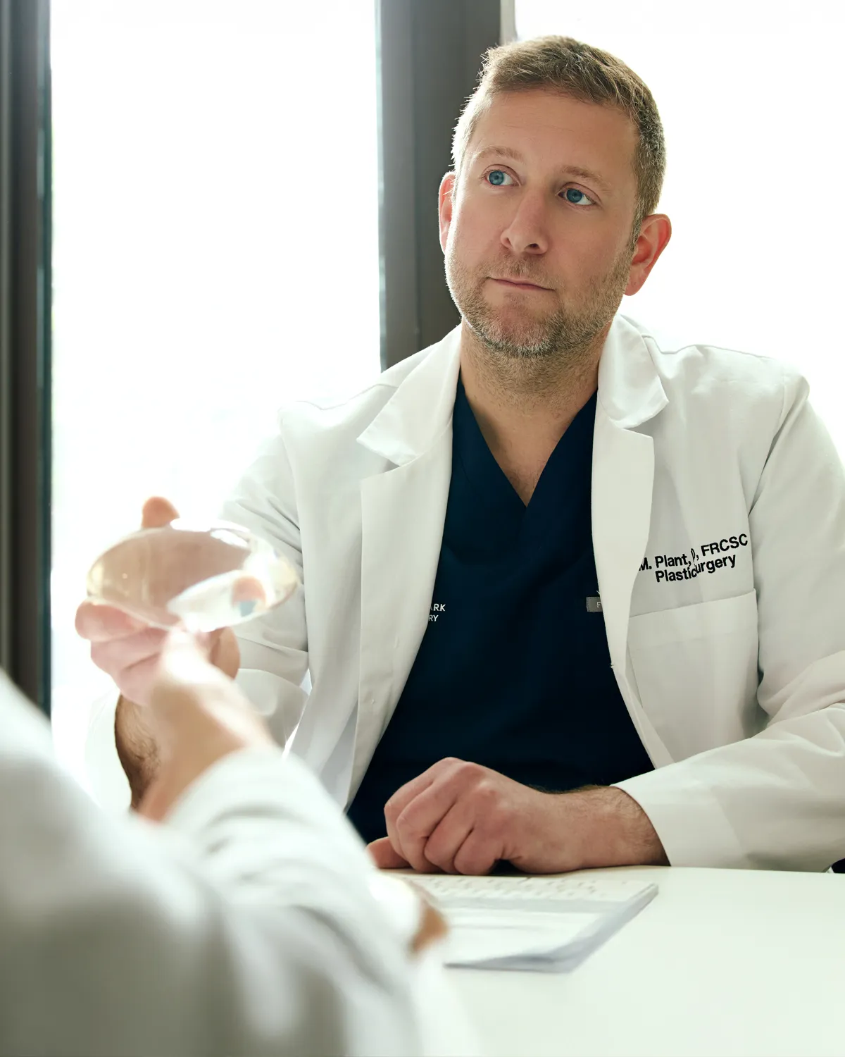 Dr. Plant meeting with a patient in his office