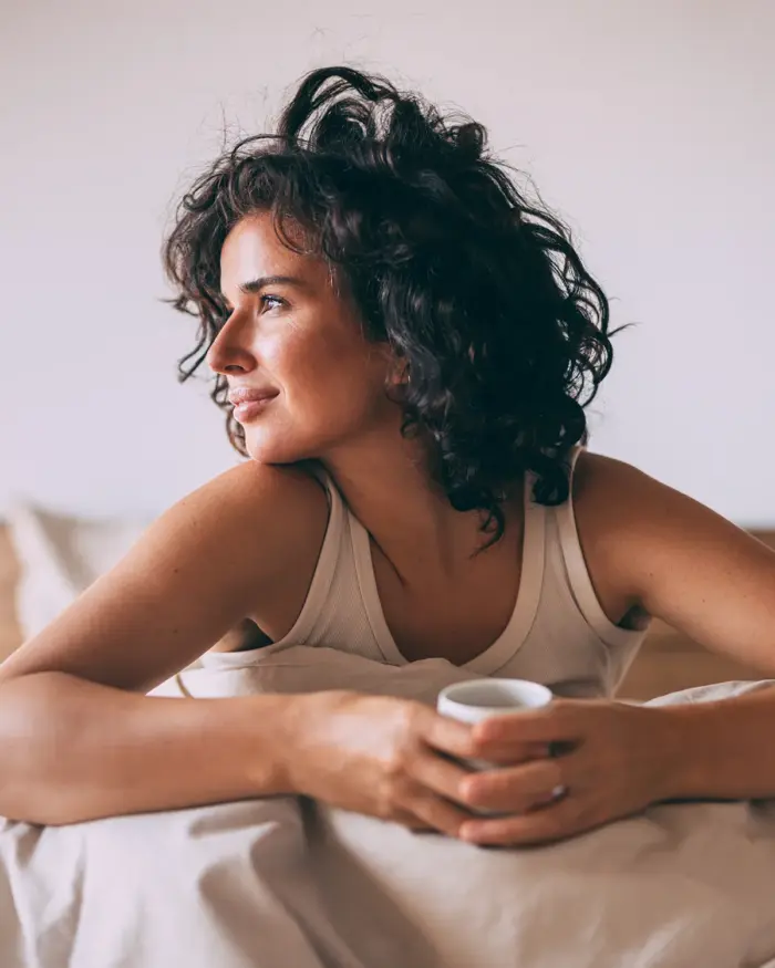 Woman resting at home in bed