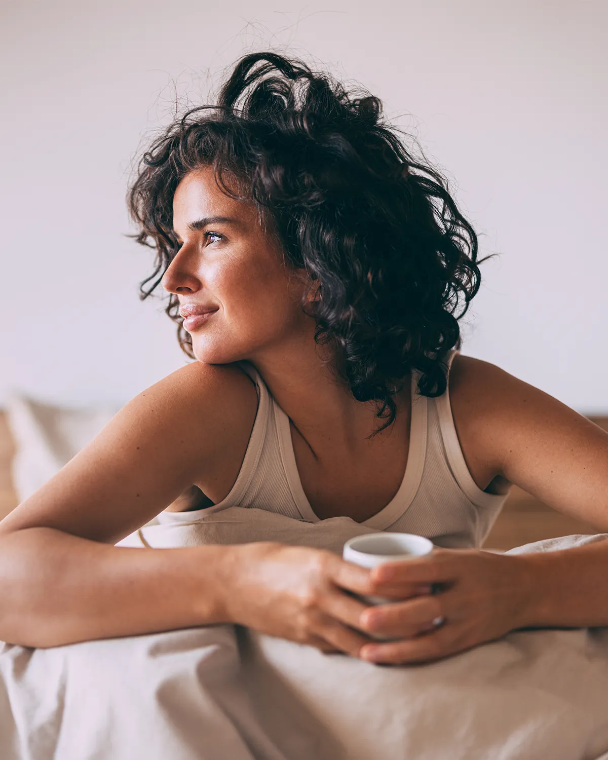 Woman resting at home in bed
