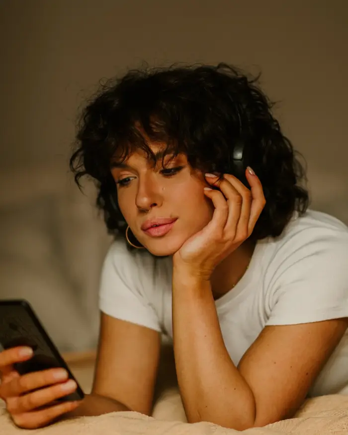 Woman lying on her stomach in a bed