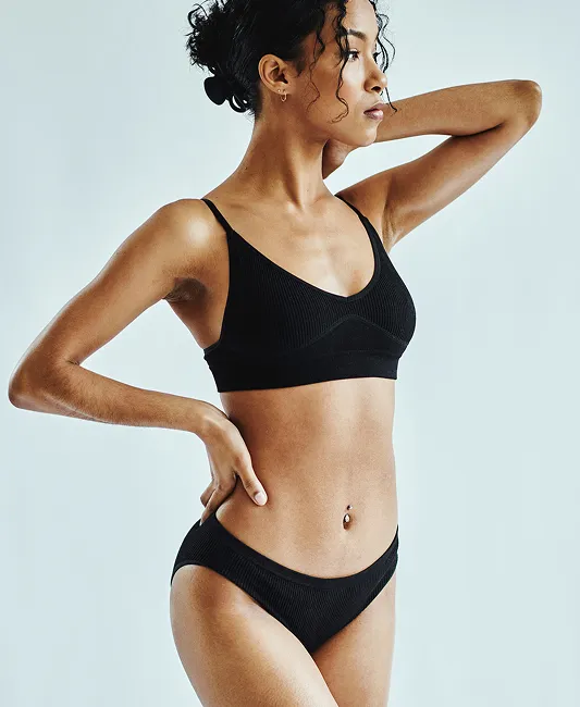 Woman standing in black undergarments
