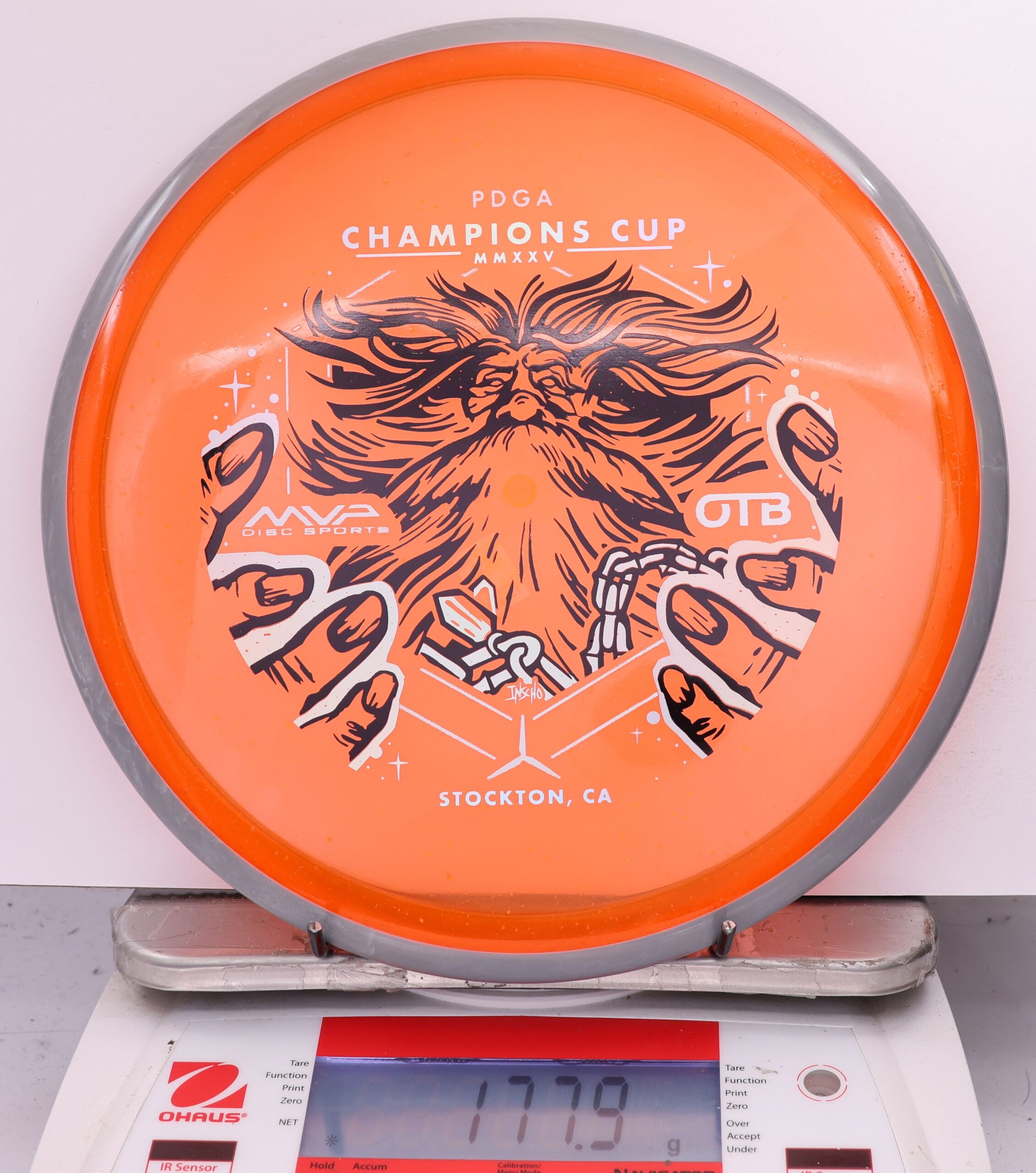 588962 Particle Glow Proton Hex, PDGA Champions Cup 2025 - #11 Gray-Orange, 178