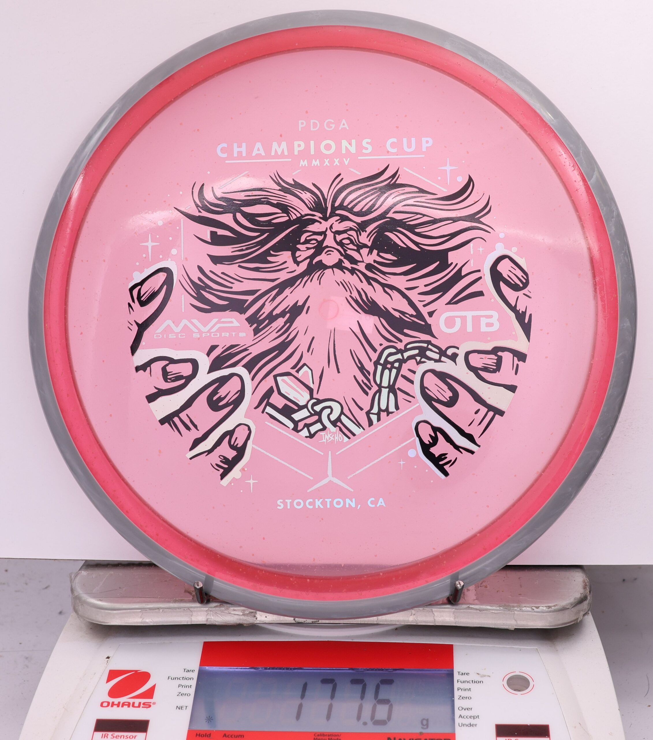 588963 Particle Glow Proton Hex, PDGA Champions Cup 2025 - #12 Gray-Pink, 178