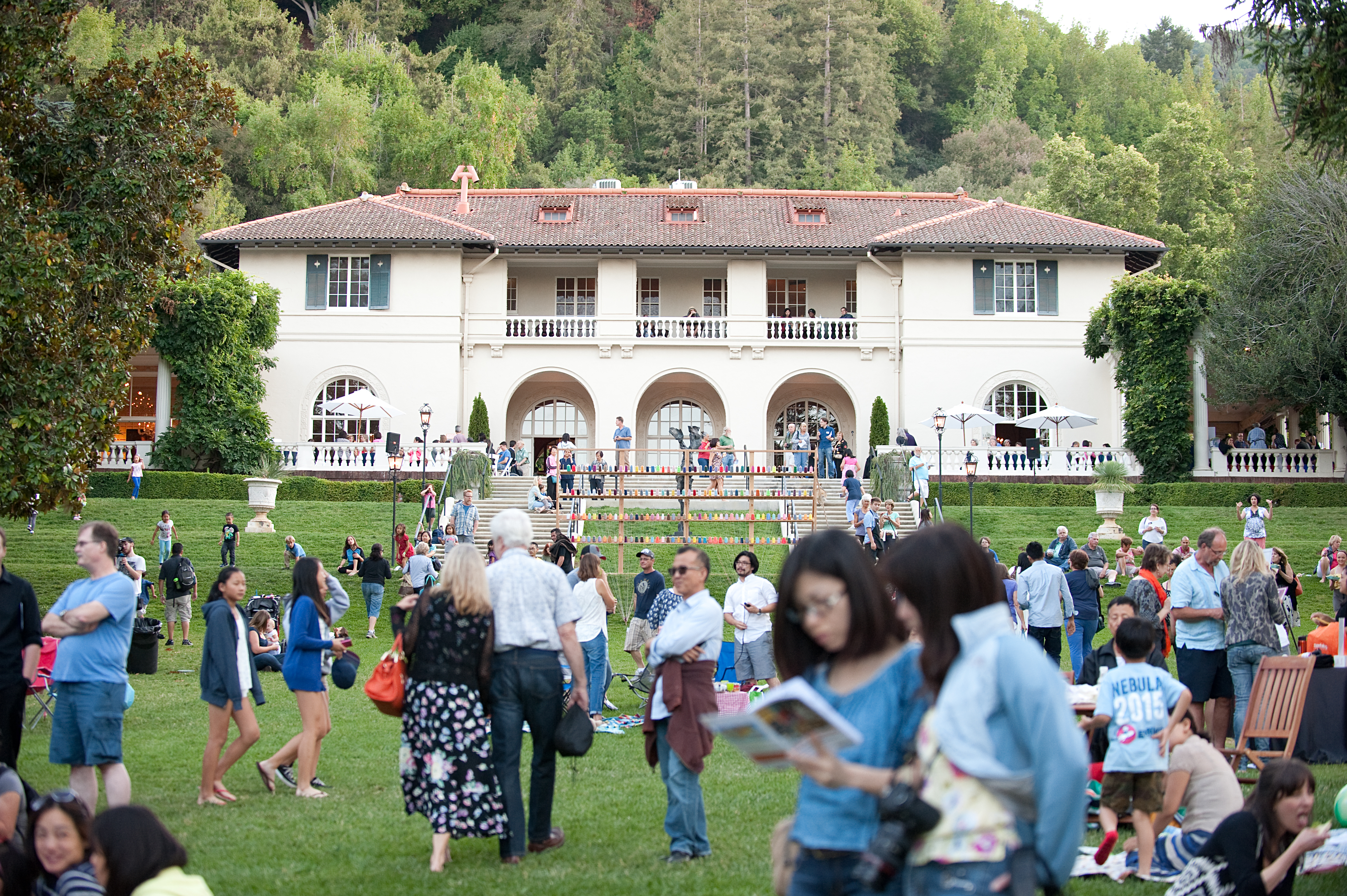 Image: A diverse crowd of people gathers on the Great Lawn at Montalvo. Photo: Bahara Emami