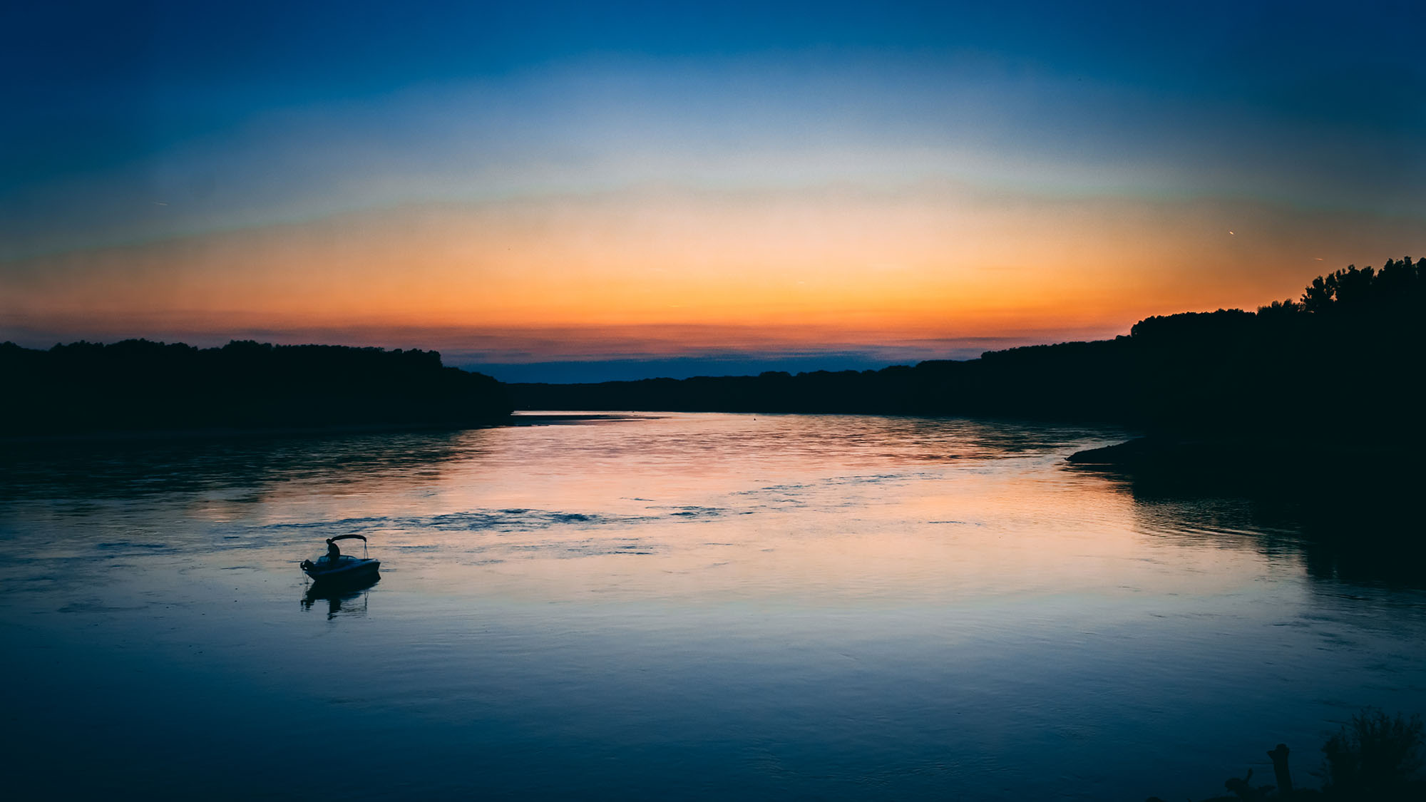 sunset-boat-sailing-orange-blue-water-1421855-pxhere.com