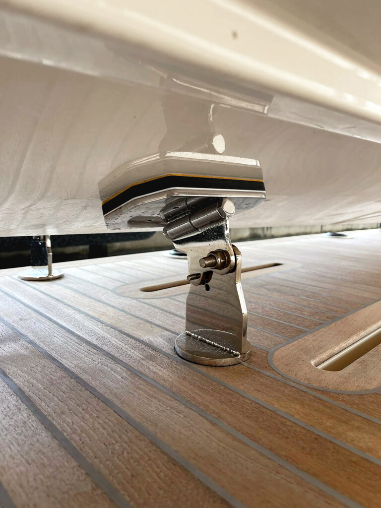 Davco AquaChocks removable dinghy chocks with stainless steel hardware, shown mounted on yacht deck.