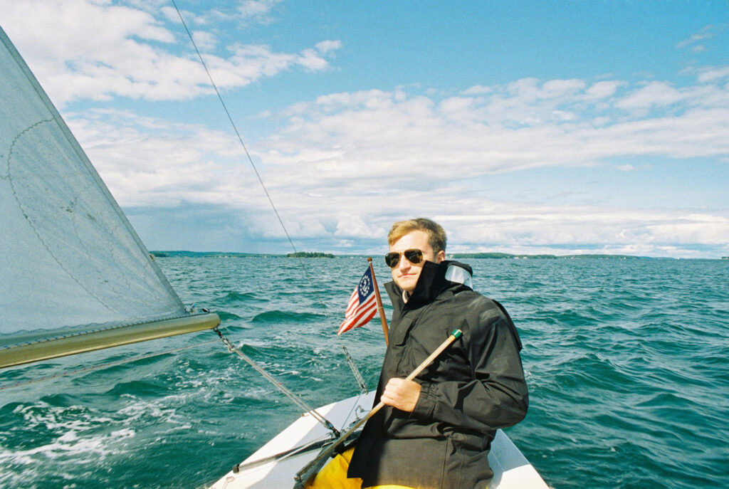 Young man in a small sailboat