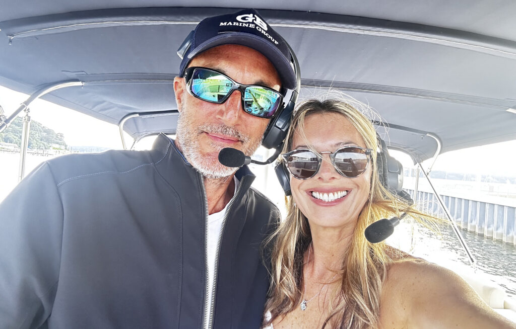Man and woman one boat's flybridge wearing communication headsets