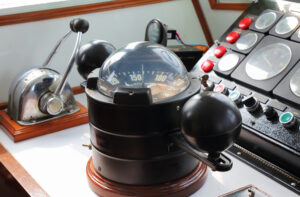big compass on a boat showing direction on daytime
