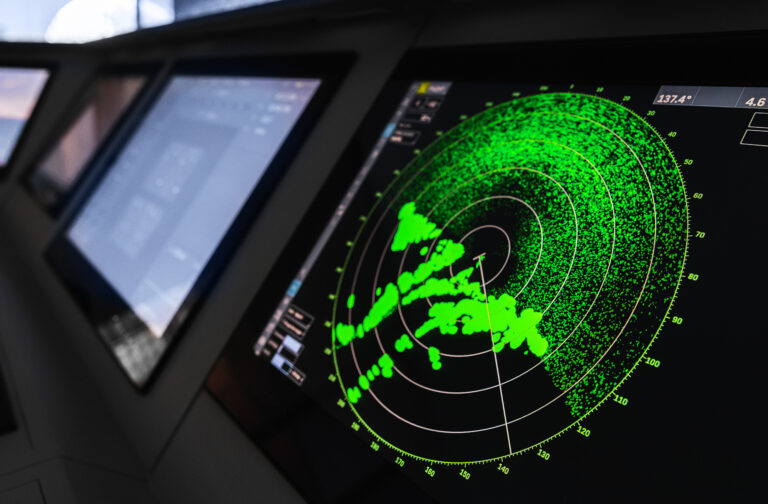 Radar screen with green display indication on a captains bridge of modern ship