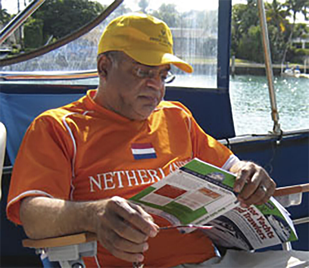 A mean reading a magazne on a boat