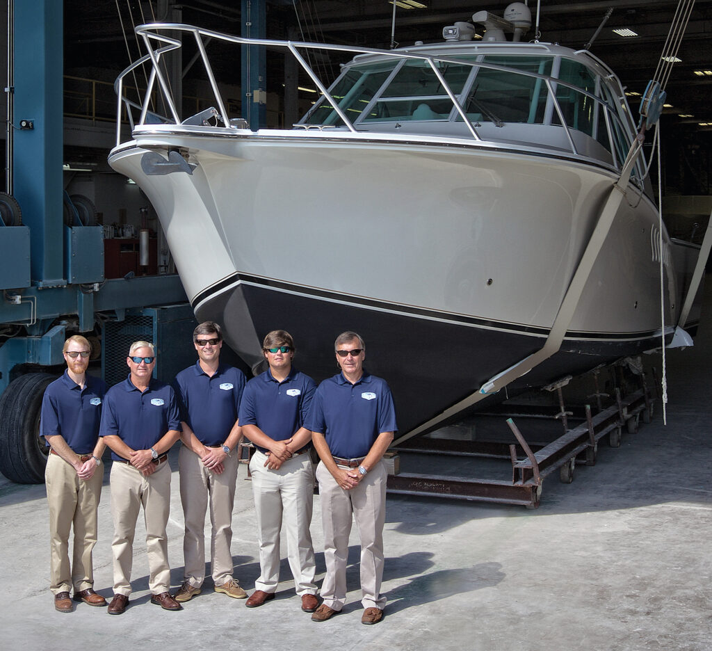 Five men in front of a boat