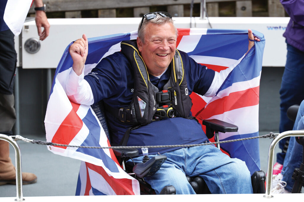 a man in a wheelchair holding a flag