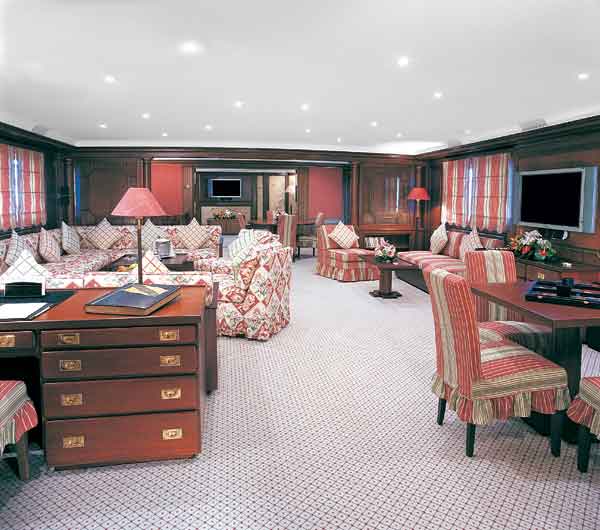 Intimate gathering areas like the saloon are populated with new soft goods and modern entertainment equipment; the wood paneling is original.