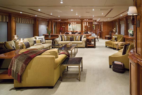 Look beyond the main saloon and past the dining room to the large, rectangular window in the far-left-hand corner of this space. It's a window into the galley and can be covered in a matching wood panel at the push of a button.