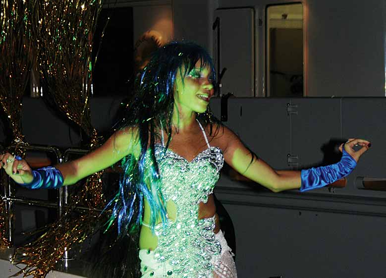 A professional dancer shakes to the music onboard Harmony.