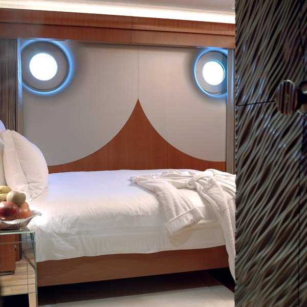 A halo effect is created by subtle reflective lighting and the use of fiberglass and silver-leaf so that the portholes almost resemble the mouth of a trumpet.