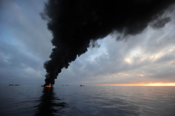 Black smoke clouds billow from a controlled burning of oil in the Gulf of Mexico, May 7, 2010. Photograph taken by Mass Communication Specialist, 2nd Class Justin Stumberg. Black smoke clouds billow from a controlled burning of oil in the Gulf of Mexico, May 7, 2010. Photograph taken by Mass Communication Specialist, 2nd Class Justin Stumberg.